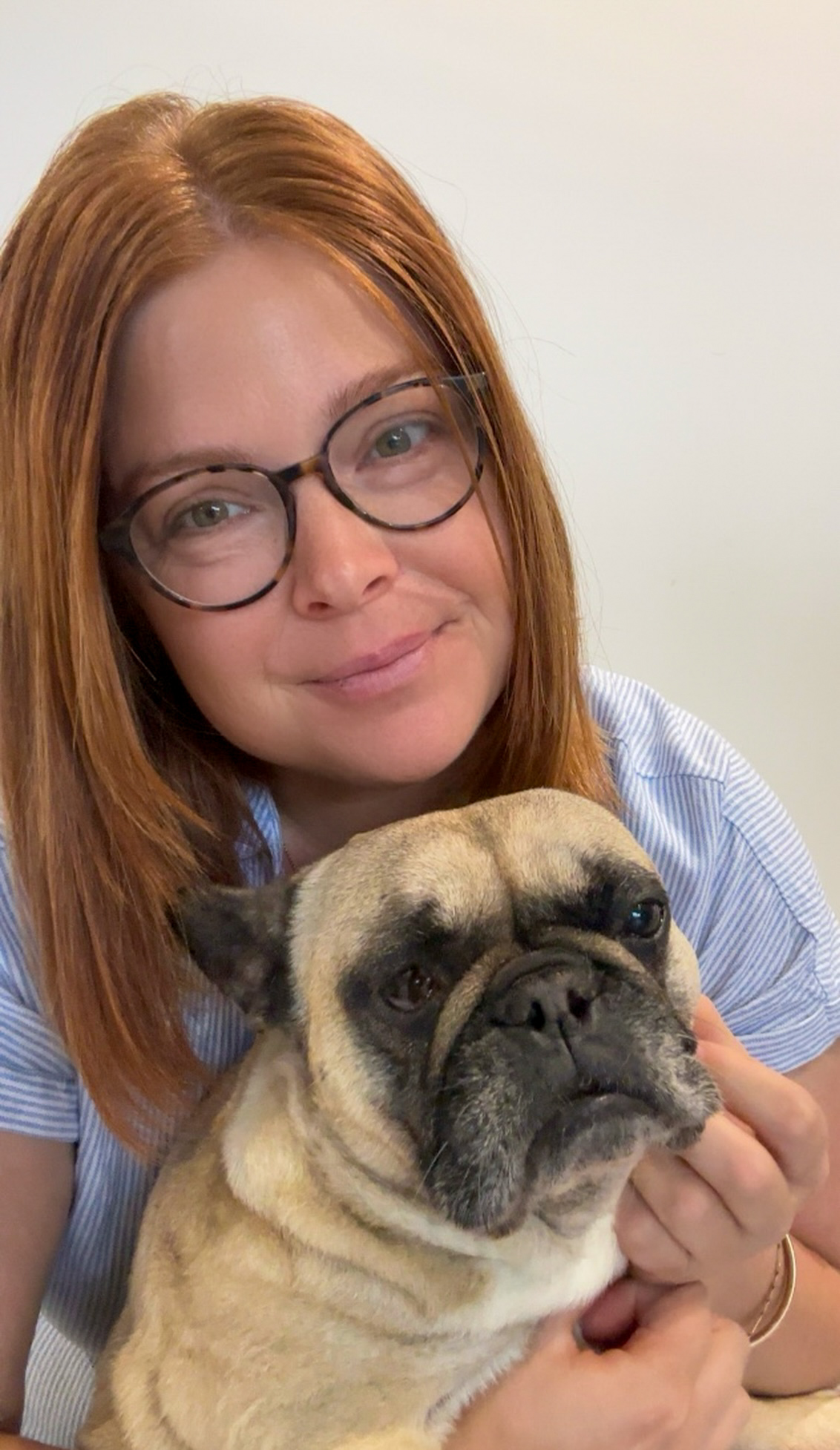 Rosie, a trusted psychic medium and Akashic Records reader, smiling with her pug, offering a no-BS approach to spiritual guidance.